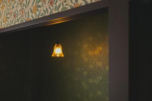 a light hanging from a wall in a room at 大同：14時からお泊まり in Osaka