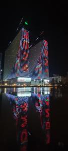 a large building with red and blue lights at night at Apart Otel Orbi City in Batumi