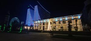 a building with christmas lights in front of some buildings at Apart Otel Orbi City in Batumi