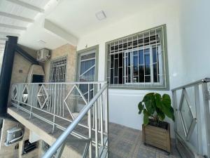 escalera con ventana y maceta en Residencial Mizinho, en Florianópolis