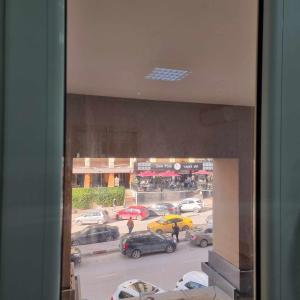 a view from a window of a parking lot with cars at Spacious Apartment Ennasr 2 in Ariana