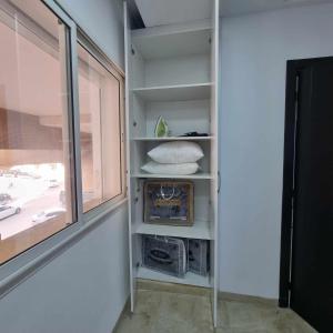 a room with a window and shelves in a room at Spacious Apartment Ennasr 2 in Ariana
