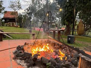 a fire pit in a park with a pile of rocks at Greenhouse Retreat in Senmonorom