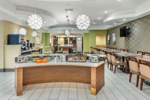 a restaurant with a counter with donuts on it at Best Western Plus New Englander in Woburn