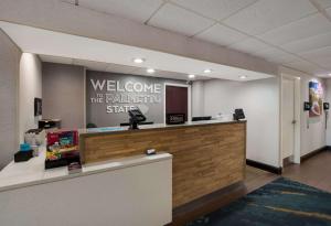 a welcome counter in an office with a welcoming sign at Hampton Inn Columbia-I-26 Airport in Columbia