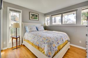 a bedroom with a bed and two windows at Laptop-Friendly Greensboro Home with Fireplace! in Greensboro