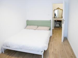 a bedroom with a white bed and a mirror at Anita Bnb Rimini in Rimini