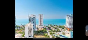 an aerial view of a city with buildings and the ocean at Salguero suites resort apartamento in Gaira