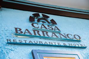 a sign for a restaurant on the side of a building at Hotel Casa del Barranco in Cuenca