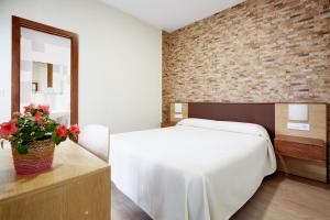Postel nebo postele na pokoji v ubytování Hostal Campo Nuevo