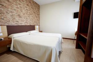Postel nebo postele na pokoji v ubytování Hostal Campo Nuevo