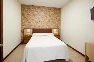 Postel nebo postele na pokoji v ubytování Hostal Campo Nuevo