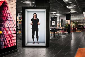 a woman standing in front of a wall at Aiden by Best Western Stockholm City in Stockholm