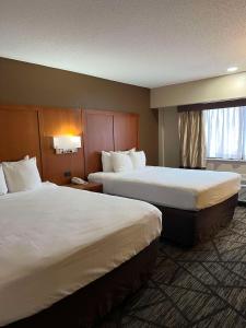 a hotel room with two beds and a window at SureStay Plus by Best Western Mobile I-65 in Mobile