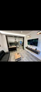 a living room with a couch and a table at Koman House in Savona