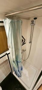 an interior of an rv with a curtain and a sink at Appartement sur l'eau tout confort in Le Barcarès
