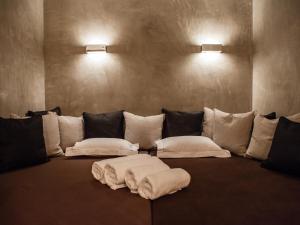 a couch with white pillows in a room at Chalet-Apartment Lavendel am Lift in Kirchberg in Tirol