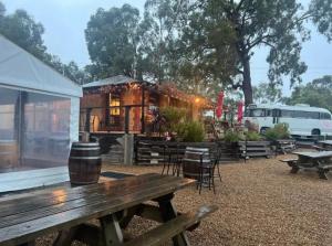 a picnic table in front of a building at Cosy Glamping Tent 6 in Ararat