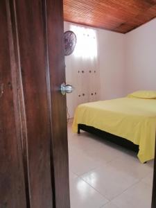 a door leading into a bedroom with a bed at Casa lowcost relajación in La Dorada