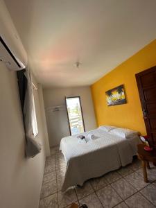 a bedroom with a white bed and a window at Pousada D Italia in São José da Coroa Grande