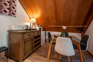 a dining room with a wooden ceiling and a table and chairs at French Peak Loft - French Farm Holiday Home in Taihape