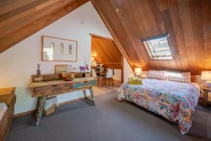 a bedroom with a bed and a desk at French Peak Loft - French Farm Holiday Home in Taihape