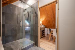 a bathroom with a shower with a glass door at French Peak Loft - French Farm Holiday Home in Akaroa +22 photos