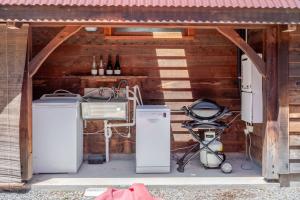 a garage with two refrigerators and a stroller in it at French Peak Loft - French Farm Holiday Home in Akaroa