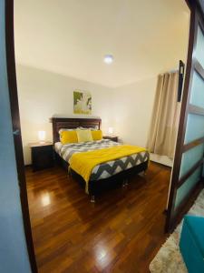 a bedroom with a bed with yellow sheets and yellow pillows at Centro Apart Santiago in Santiago