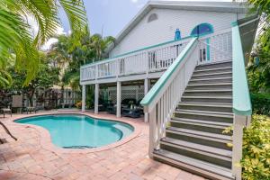 a house with a swimming pool and stairs next to a house at Sail Away Cottage in Bradenton Beach