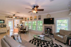 a living room with a couch and a fireplace at Sail Away Cottage in Bradenton Beach