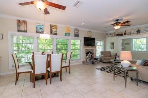 a living room with a table and chairs and a fireplace at Sail Away Cottage in Bradenton Beach