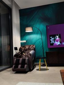 a chair sitting in a room with a tv at Villa 81 Sanctuary Hồ Tràm Resort, built on Jun 2023 in Ho Tram
