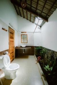 a bathroom with a toilet and a sink at La Mer Resort, Phú Quốc in Phú Quốc
