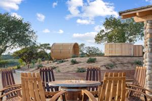 a patio with a table and chairs and a barrel at Private Ranch Retreat in Lompoc