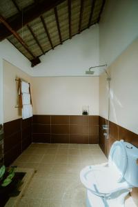 a bathroom with a toilet and a sink at La Mer Resort, Phú Quốc in Phú Quốc
