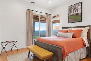 een slaapkamer met een bed en een groot raam bij Private Ranch Retreat in Lompoc