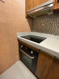 a kitchen with a sink and a counter top at BSA TWIN TOWER in Manila