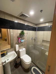 a bathroom with a toilet and a sink and a shower at BSA TWIN TOWER in Manila