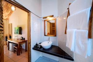 a bathroom with a sink and a mirror at La Mer Resort, Phú Quốc in Phú Quốc