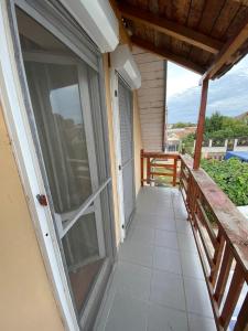 a balcony with a sliding glass door on a house at Cosy bedroom for 2 with Balcony in a Family Villa in Turnu Măgurele