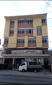 a white truck parked in front of a building at Apartamento Centro ao lado do Country Club in Nova Friburgo