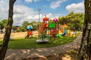 a colorful playground in a park with trees at Coliving7 Aparta Hotel & Habitaciones in Ibagué