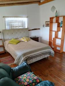 1 dormitorio con 1 cama y 1 sofá en una habitación en Las Chunas en Villa Yacanto