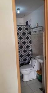 a bathroom with a toilet and a shower curtain at CRYSTAL CONDO RENTAL in Calamba