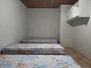 a room with three beds in a room at Casa de Praia Completa em Cabo Frio 04 para até 5 Pessoas in Cabo Frio