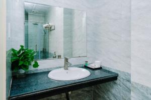 a bathroom with a sink and a mirror at Lang Chai Hotel Cat Ba in Cat Ba +57 photos