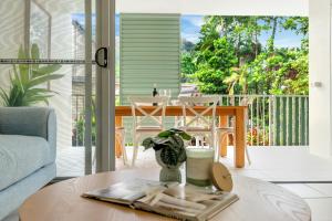 a living room with a coffee table and a patio at Botanical- Edge Hill Village in Edge Hill