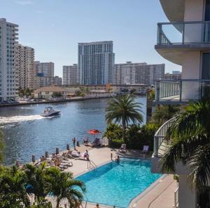 a swimming pool in the middle of a river with buildings at Iconic View - Family 2BR Suite - Hotel - Fiber Internet in Hallandale Beach