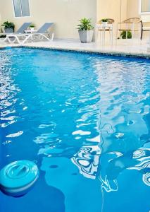 a swimming pool with a frisbee in the water at Profil Bois Pin 